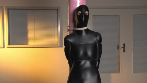 Spandex zentai babe with fishing line tied to concrete post
