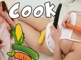 Chubby blonde cook inserting cucumber, carrot and corn