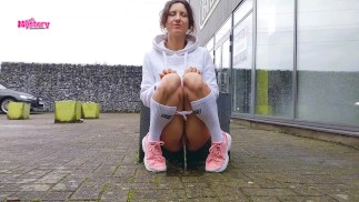 Naughty girl pees in front of the store