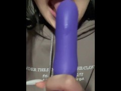 A beautiful girl spoils herself with a toy.