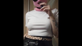 smoking girl in a pink balaclava and a cat mask