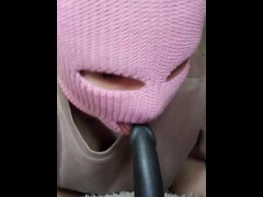 girl in thong with hello kitty and pink balaclava gives blowjob to black dildo