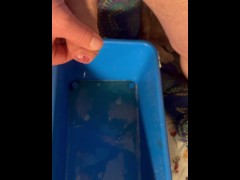 Pissing in a bucket face visible