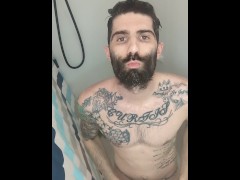 Sexy tattoo man taking shower