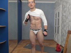 Russian guy lifts a dumbbell in sexy underwear