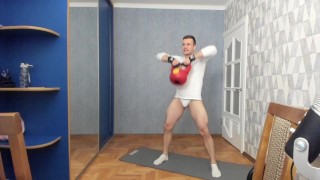 Russian guy lifts a dumbbell in sexy underwear