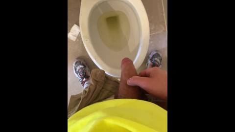 Construction worker pissing in the toilet