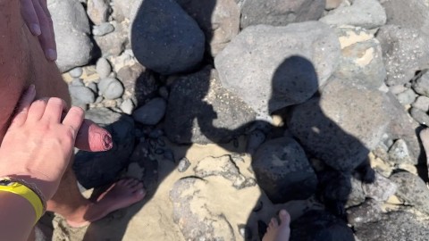 girl helps stranger piss and touches penis On public beach