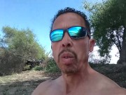 Naked muscle by a lake near people