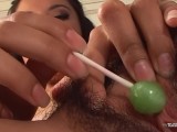 Bushy babe masturbates with a lollipop before using a sex toy