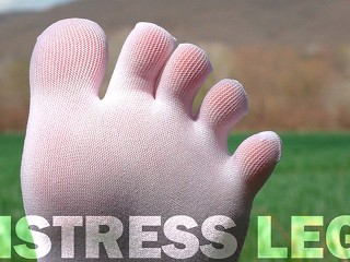 Goddess Feet in cute white socks with jeans on the spring grass field Video