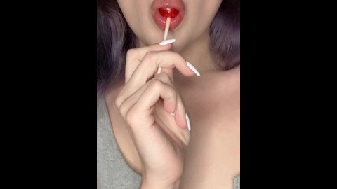 Pretty little mouth sucks lollipop