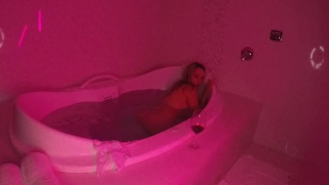 Blonde with a pink pussy shows off in the hot tub