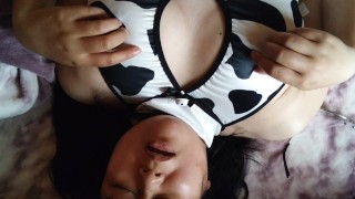 A Japanese woman cosplaying as a cow has an orgasm while masturbating her nipples.