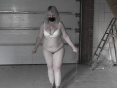 A mature bbw milf with a hairy pussy and big saggy natural tits is jumping rope.