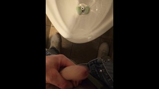 Pissing in a public urinal