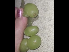 Smashing juicy grapes under my big toes close up under and side pov