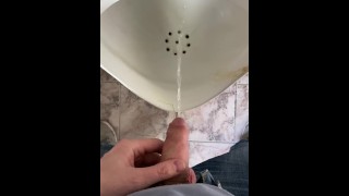 Guy pees in a public toilet POV