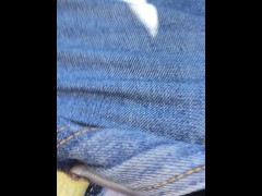 Pissing out of a car in a public car park with a boner