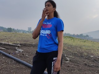 Woman Smoking Nearby Lake
