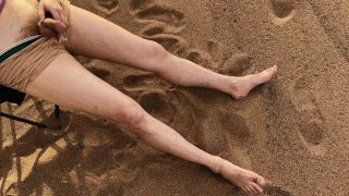 A man pissed on the feet of a guy who was relaxing on a public beach. Pissing in nature
