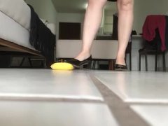 Preparing to crush banana wearing high heels - preview