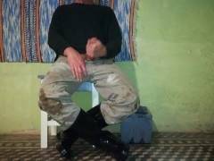 Farm man takes care of his rubber boots at the end of the day