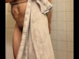 Hairy muscle bear flexing in hot shower