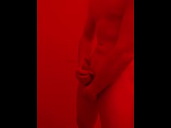 Horny boy Stroking Cock under the red lights