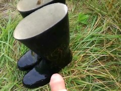 The satisfied peasant man pees on his rubber boots