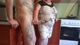 my mother-in-law saw my cock and began to milk it until I finished