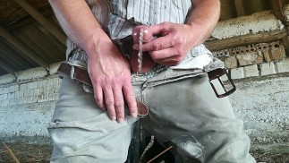 the peasant in rubber boots repeatedly pees in his pants and masturbates in the barn
