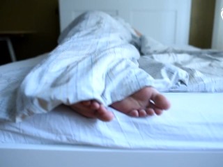 Girl's Bare Feet in Bed