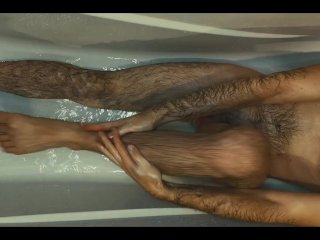 Hairy guy soaps up in bath, strokes, plays with his dick and foreskin and pisses on himself