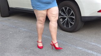 Pissing in public  - busty milf in mini dress showing off big juicy ass and flashing pussy close up
