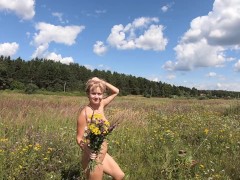 Naked girl picking flowers