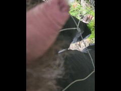 Outside near the wire pissing under pressure