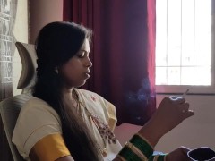 Woman smoking cigarette in saree