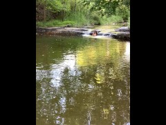 Girl exposes breasts under the waterfall