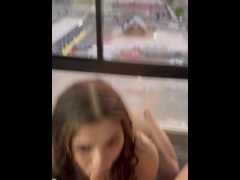 City slut sucks cock with a nice view