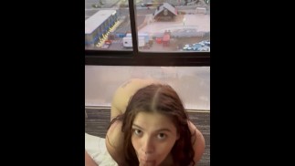 City slut sucks cock with a nice view