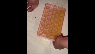 Girl fills ice cube tray with piss