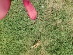 Walking around barefoot wearing red nylon stockings