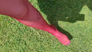 Walking around barefoot wearing red nylon stockings