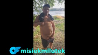 A young Teddy Bear with a small dick is masturbating on the river bank