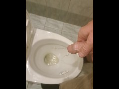 Guy peeing in office toilet