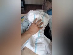 A trans girl urinates in a diaper, licks it and masturbates
