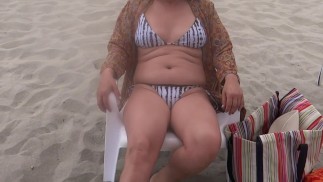 Beautiful stepmother on the beach very excited shows off and starts touching herself, she needs to f