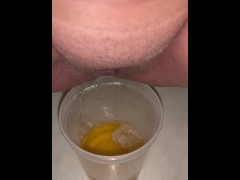 Girl Peeing in a plastic soup to go container