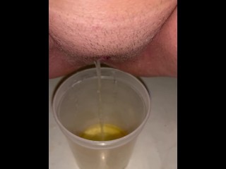 Girl Peeing in a Plastic Soup to go Container